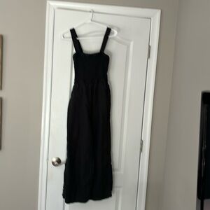 J Crew black linen jumpsuit with smocked top, pockets and wide legs.
